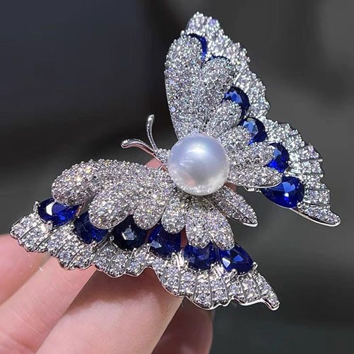 hand holding butterfly brooch